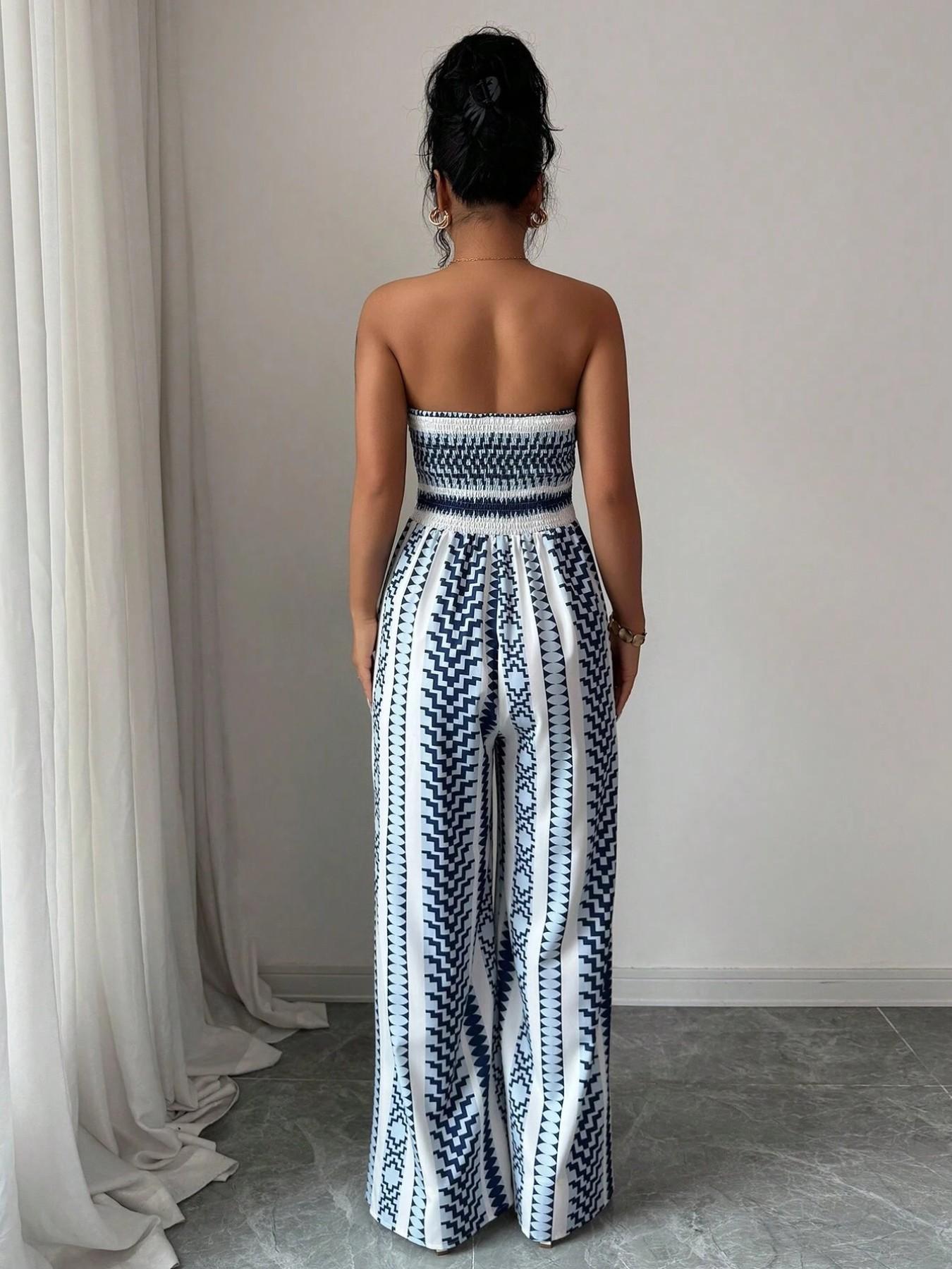 👗💙 Geometric jumpsuit with halter neckline and side slit!