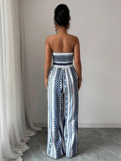 👗💙 Geometric jumpsuit with halter neckline and side slit!